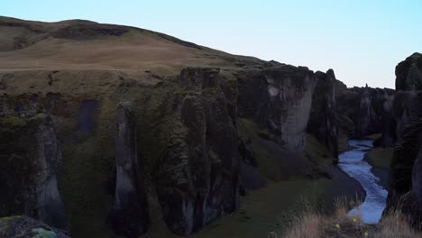 river in crevice or canyon between two rocky cliffs in iceland