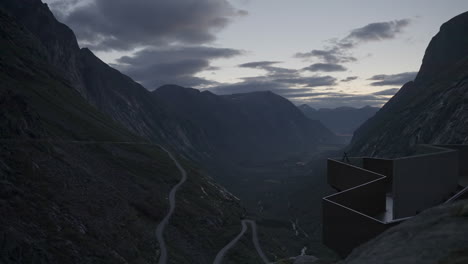 viewpoint overlooking valley surrounded by imposing mountains, scenic road