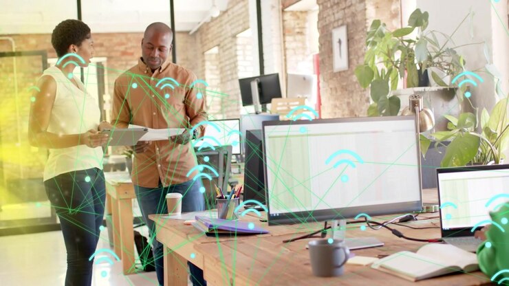 Vertical video: Team reading doc and pointing syncing IT plan as teal WiFi icons drifting over team