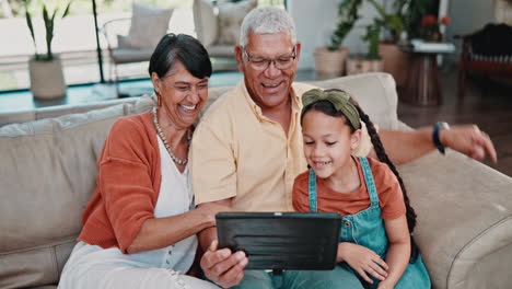 grandparents, granddaughter, and tablet