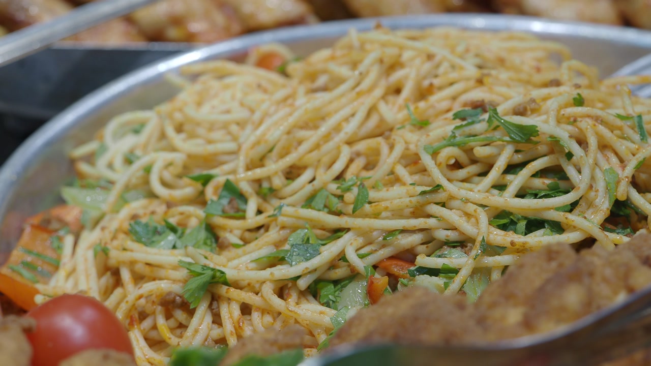 Appetizing Spaghetti with Fresh Herbs and Vegetables in a Serving Dish