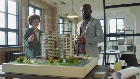 architects or developers discussing a building model in an office