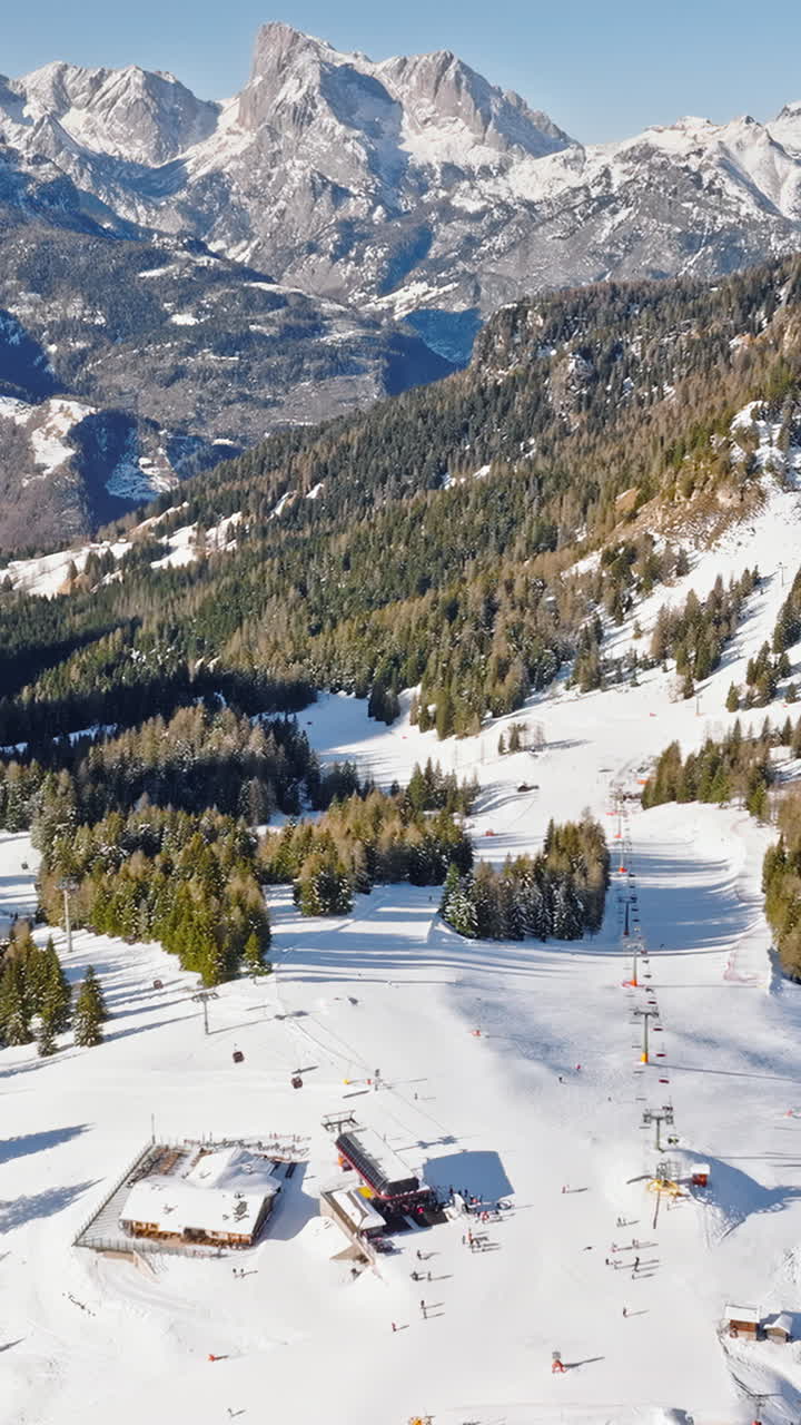 Aerial drone view of a ski resort in Col dei Baldi, Alleghe, in the Dolomites, Italy in daylight. Vertical