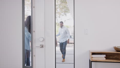 parents bringing excited children back home from school opens front door of house