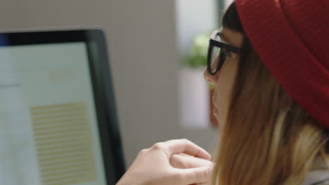 close-up-young-hipster-business-woman-looking-bored-at-work-relaxing-wearing-beanie-hat-in-office-workplace