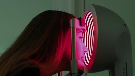 corneal topography. eye exam with corneal analyzer for beautiful woman