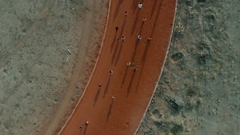 aerial of children running on a clay circuit