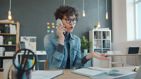 woman arguing on phone in office