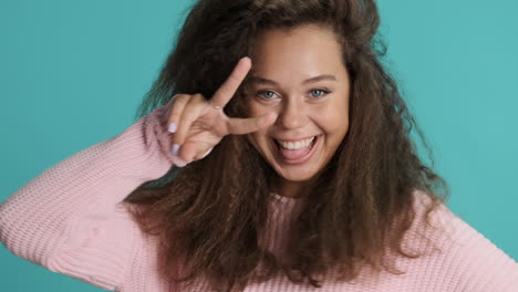 caucasian curly haired woman making funny faces in front of the camera.