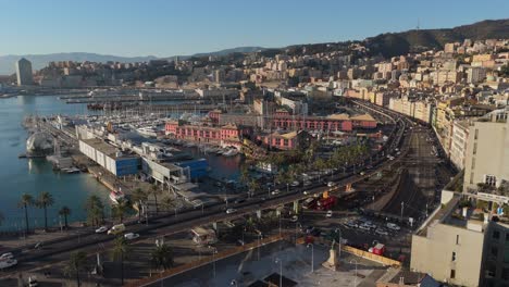 Sunset-over-Genoa's-bustling-port-and-historic-buildings,-with-palm-trees-and-traffic