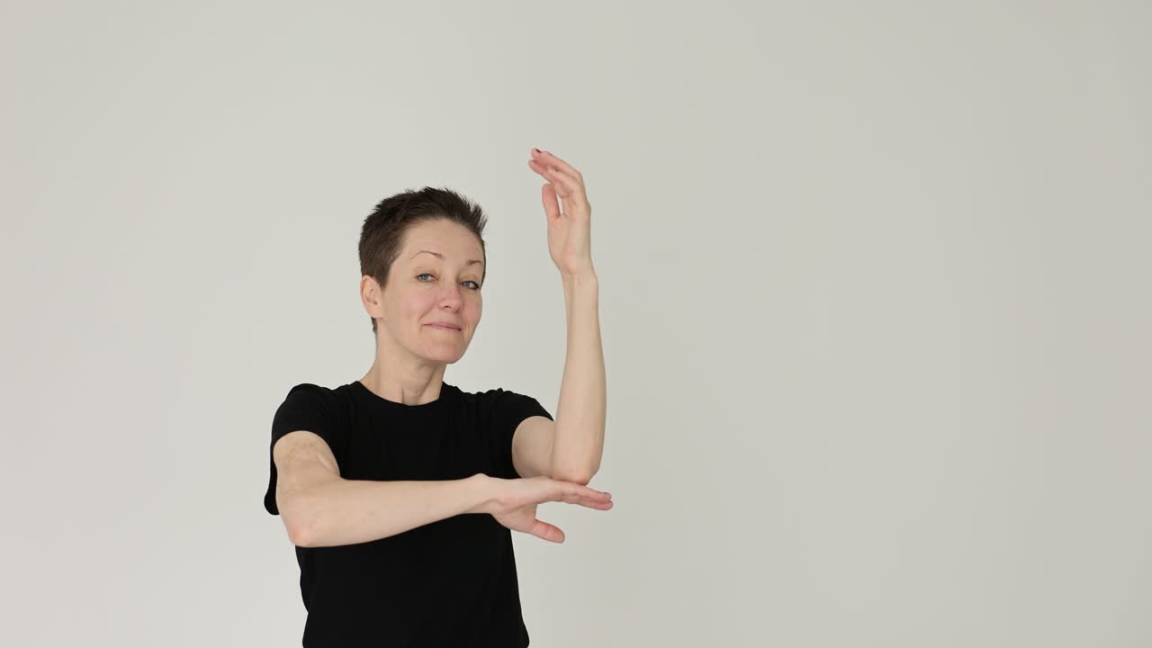 Woman indoors in a black t-shirt