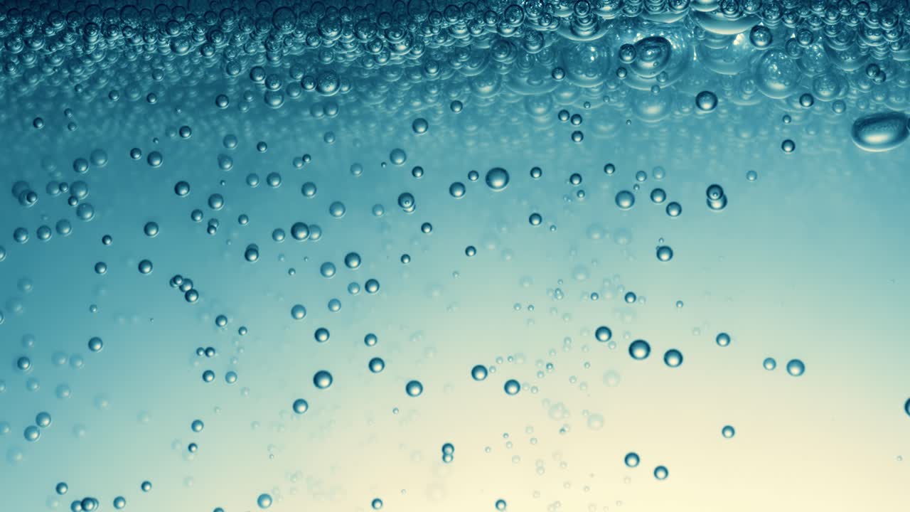 Many water bubbles in blue water close up, abstract water wave with bubbles in slow motion.