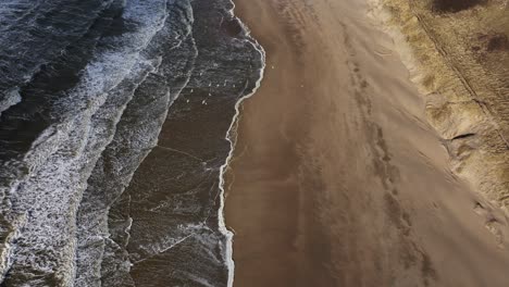 aerial view of a beach and waves