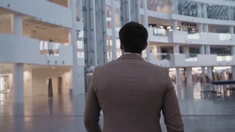 Businessman walking through modern building