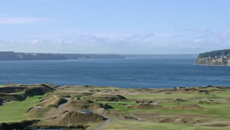 a view of mcneil island, anderson island, and the chambers bay golf course