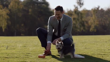 man playing with a dog in a park