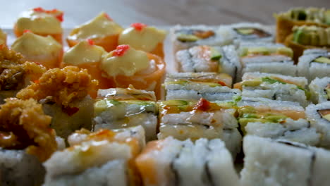 close-up trucking slider shot of delicious looking mixed sushi platter