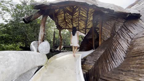 woman enjoying a water park slide in the jungle