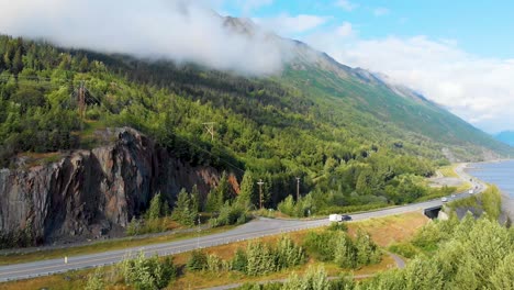 4k drone video of alaska route 1 along mountain shoreline of turnagain arm