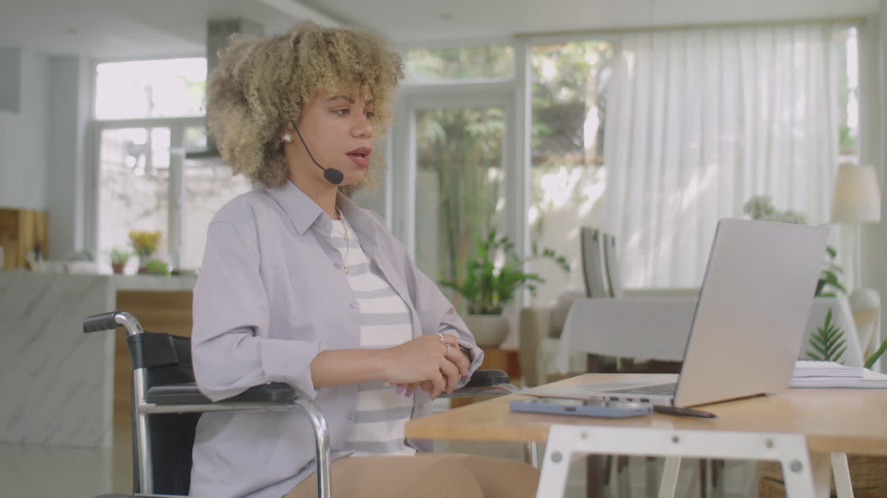 Woman in Wheelchair Having E-Meeting on Video Call