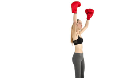 Fit-model-cheering-with-red-boxing-gloves