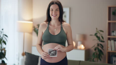 pregnant woman holding ultrasound picture