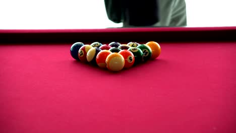 playing the pool-billiard game on red baize table. this is sports