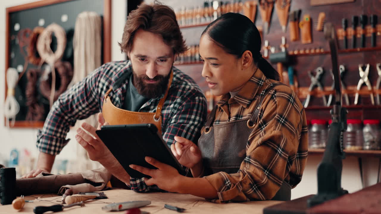 Leather work, man and woman with tablet