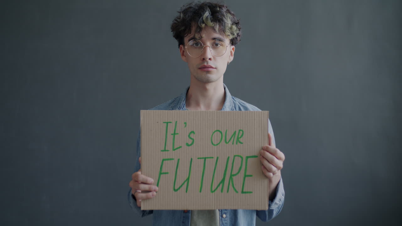 Young Man Holding a Protest Sign