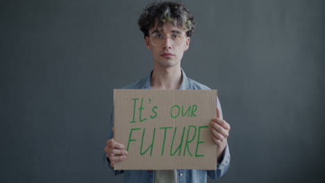 young man holding a protest sign