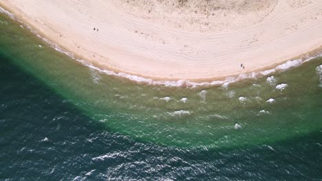 Top-down-aerial-clip-over-a-tropical-beach-with-golden-sand-in-the-area-of-Keramoti,-Kavala,-in-Northern-Greece-in-4k