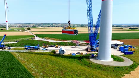 crawler crane lifting nacelle at wind turbine installation site