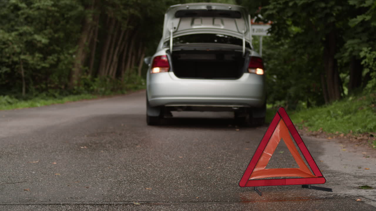 Car breakdown with warning triangle on road