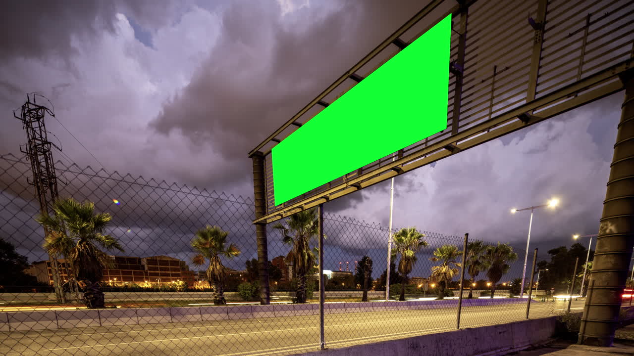 Rush of traffic on highway in city with green screen on the overhead video
