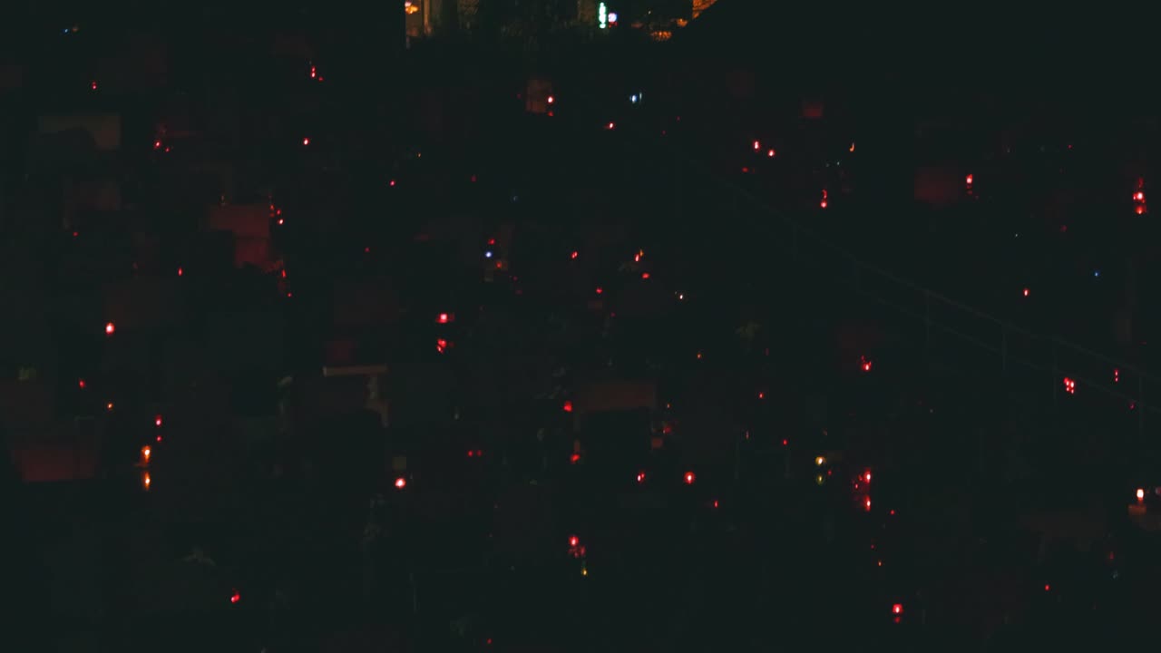 Candle lights blinking in the cemetery at night