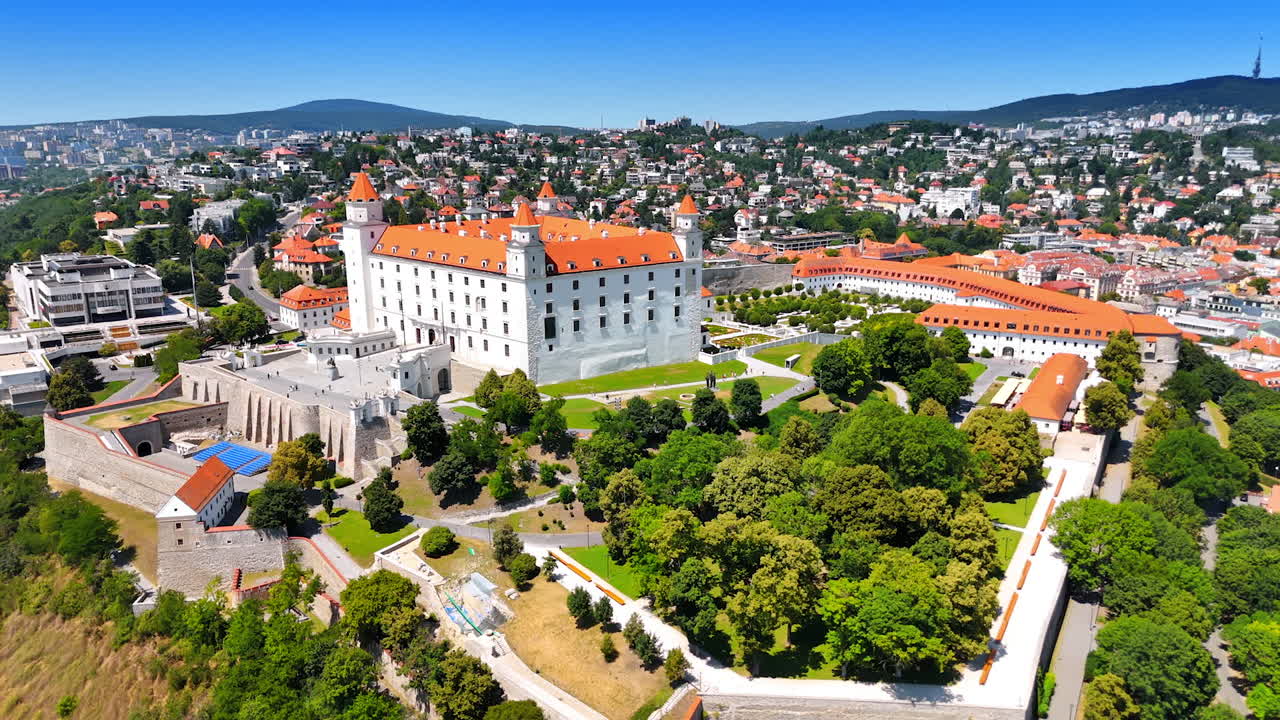 Flight around the beautiful area of Bratislava Castle on sunny day. Historical part of the Slovak capital at backdrop
