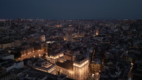 aerial night footage of lit landmark cathedral in historic old town, valencia, spain