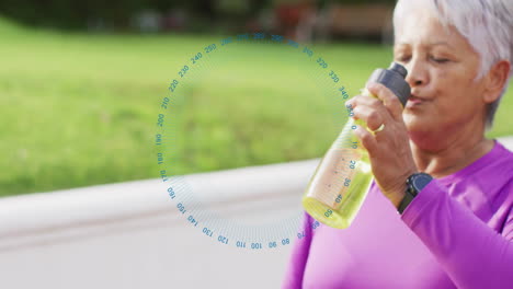 senior woman drinking from water bottle outdoors, showing fitness smartwatch and health stats