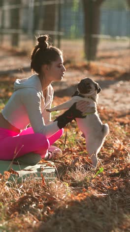 woman with a pug in a park