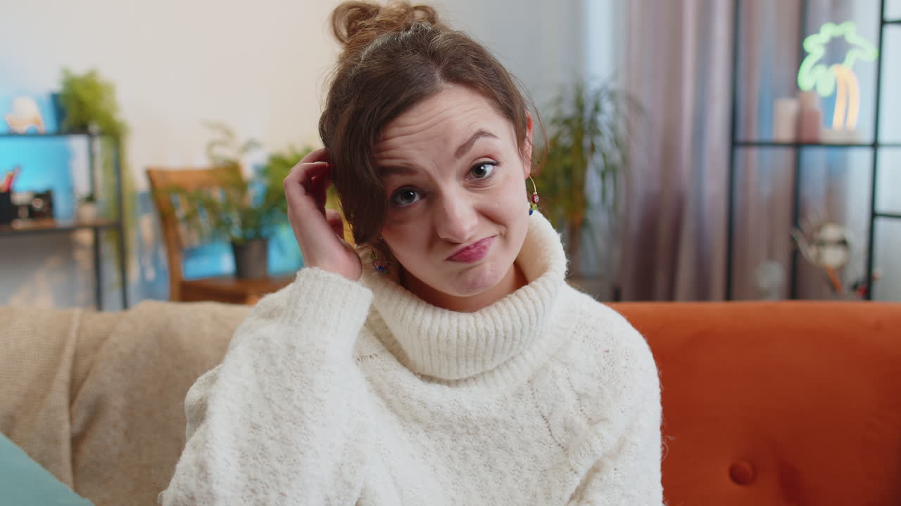 Confused young woman feeling embarrassed about ambiguous question having doubts no idea no answer