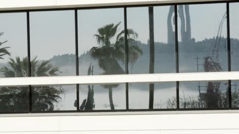 pan to the left of a building with reflection of windows of lisbon