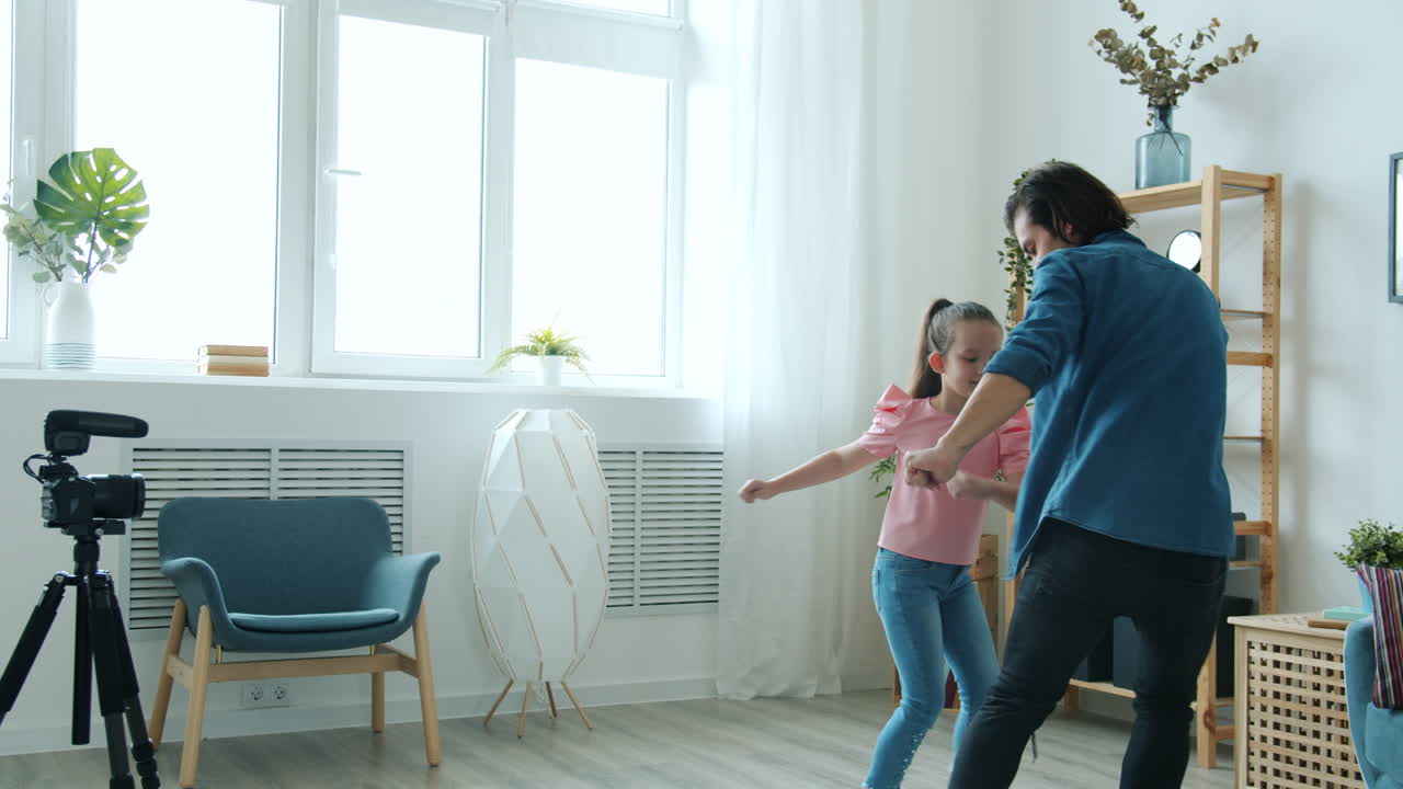 Father and Daughter Dancing at Home