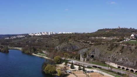 A-train-travels-across-country-towards-a-cityscape-passing-in-and-out-of-tunnels