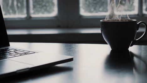 laptop and coffee by the window