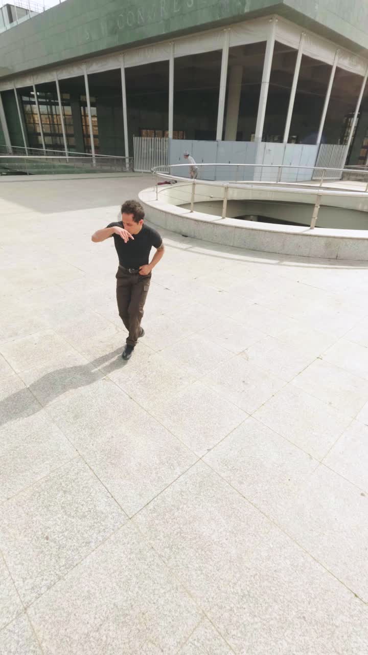 Breakdancer performing acrobatics outdoors in urban environment