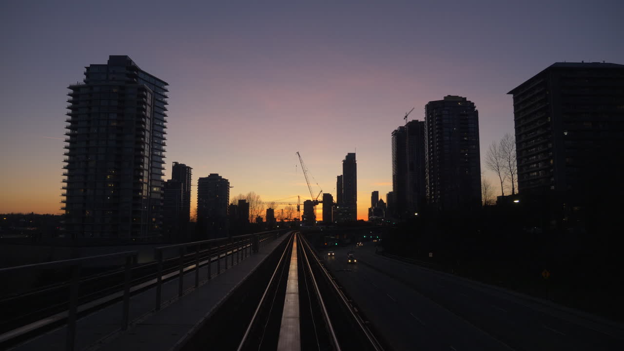 Riding the metro rail through the beautiful city of Vancouver during sunset - wide rolling