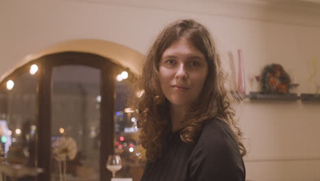 beautiful female pianist looking and smiling at camera at restaurant 1