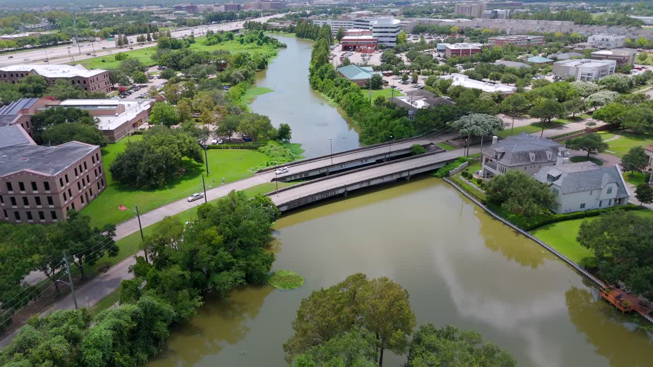 An aerial recording of 2 side-by-side bridges with light traffic