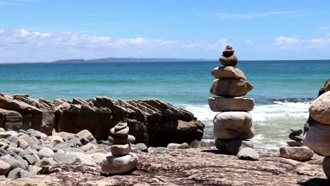 Rock-Tower-on-the-Beach-with-waves-as-background