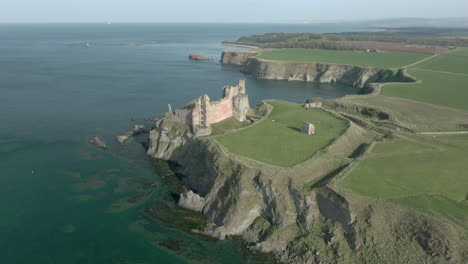 an aerial view of the front of tantallon castle ruin on a sunny day, east lothian, scotland